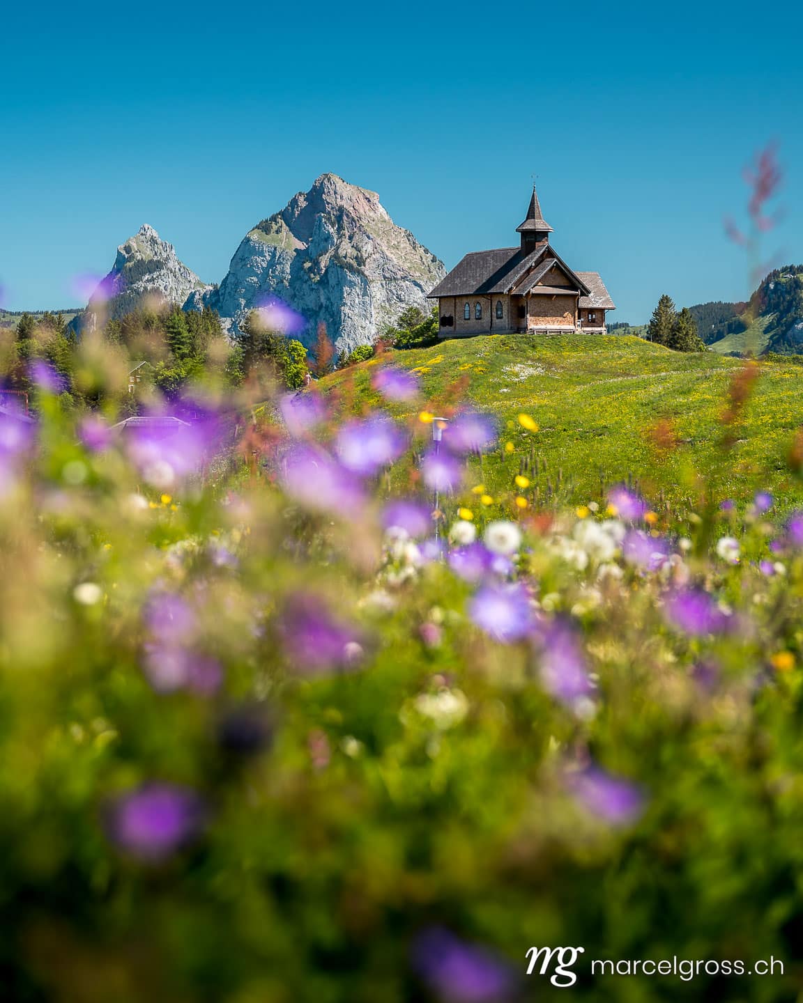 Stoos mountain chapel in front of the Mythen mountain during the Alpine summer. (c) Marcel Gross Photography
