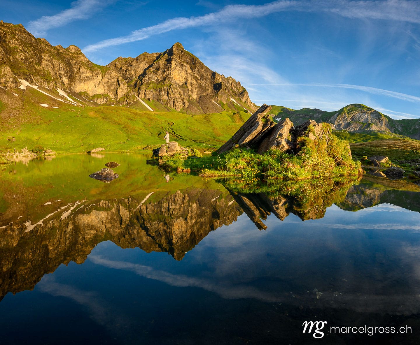 Sommerbilder Schweiz. peak of Hochstollen with reflection in alpine lake near Melchseefrutt at sunrise in the swiss alps. Marcel Gross Photography