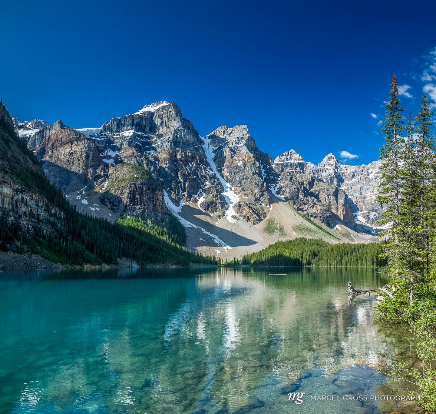 turquoise Moraine Lake with reflection in Banff National Park. Taken by Marcel Gross Photography