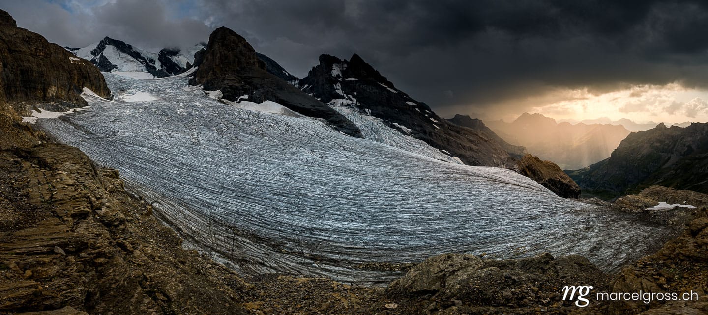 Sommerbild Schweiz. panorama of Blümlisalpgletscher at Blüemlisalphütte SAC in dramatic afternoon light. Marcel Gross Photography