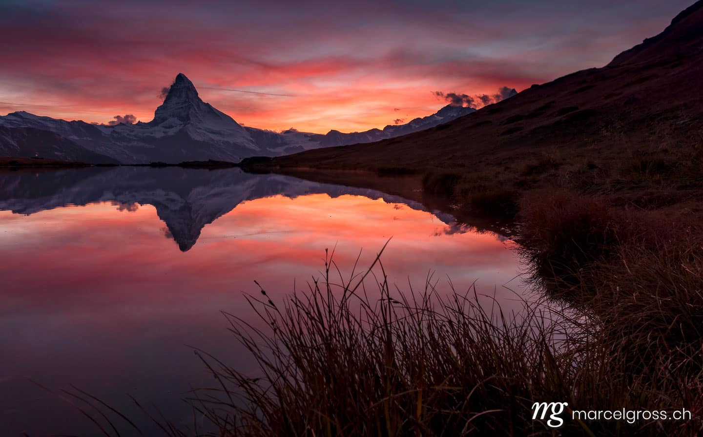 . burning sky with Matterhorn and reflection in alpine lake. Marcel Gross Photography