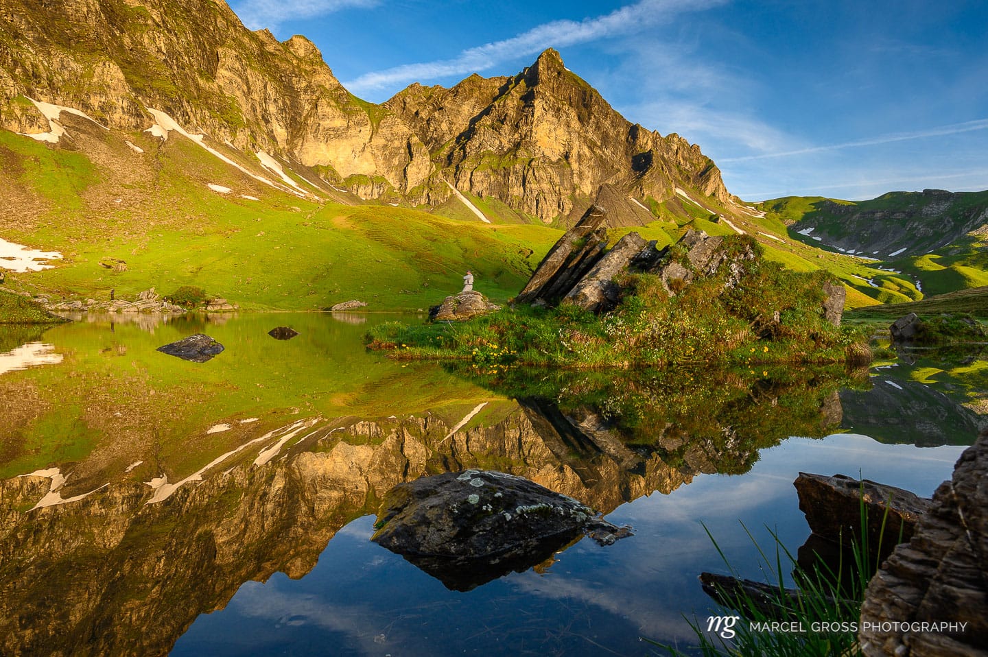 Peak of Hochstollen with reflection in alpine lake near Melchseefrutt at sunrise in the swiss alps. Taken by Marcel Gross Photography
