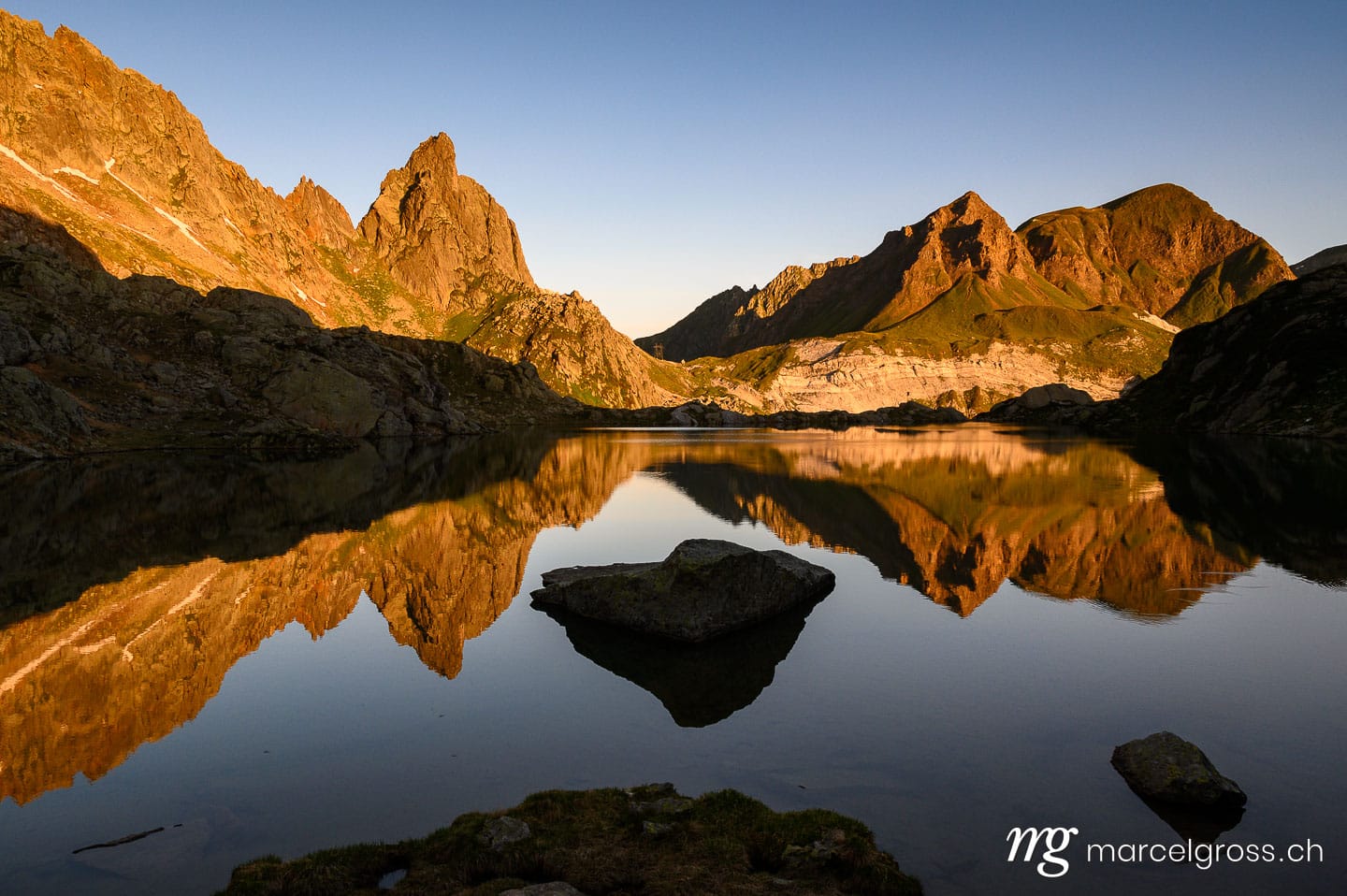 . calm Lago di Lei and Pizzo Prèvat in the Ticino Alps at sunrise. Marcel Gross Photography