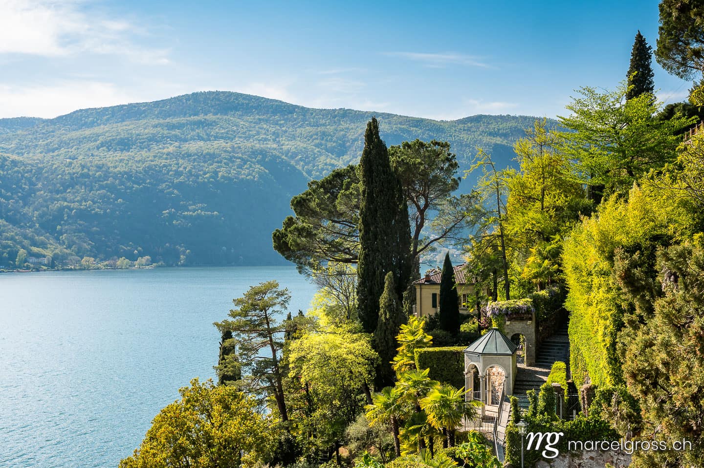 Tessin Bilder. lush garden in Morcote in spring with a view of Lake Lugano. Marcel Gross Photography
