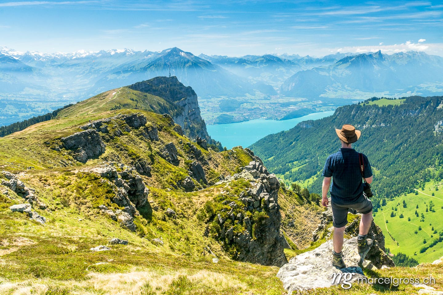 . hiker overlooking Niederhorn, Lake Thun and Niesen. Marcel Gross Photography
