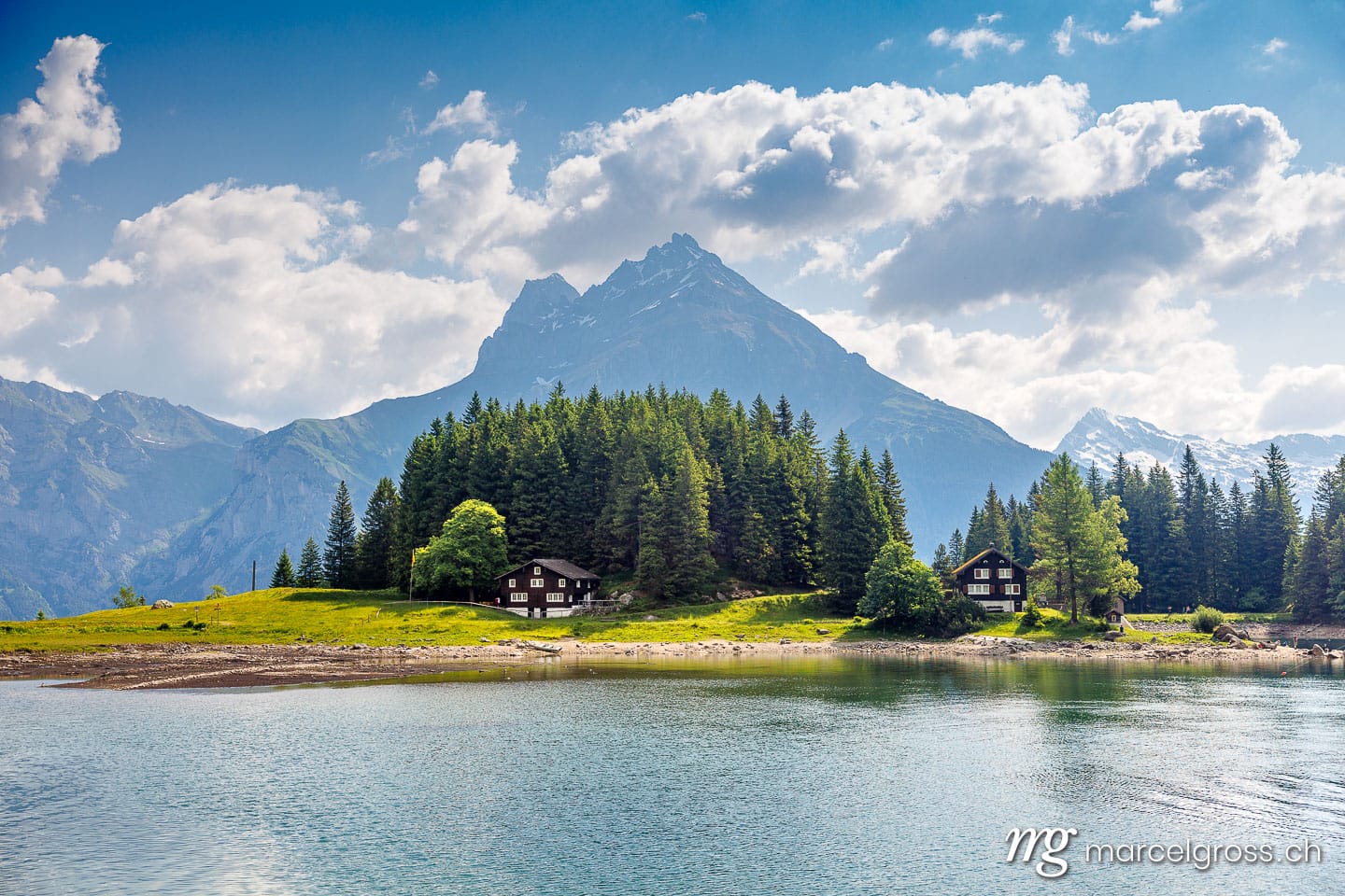 . house at lake Arnisee in the Urner Alps with Windgällen in the background in summer. Marcel Gross Photography