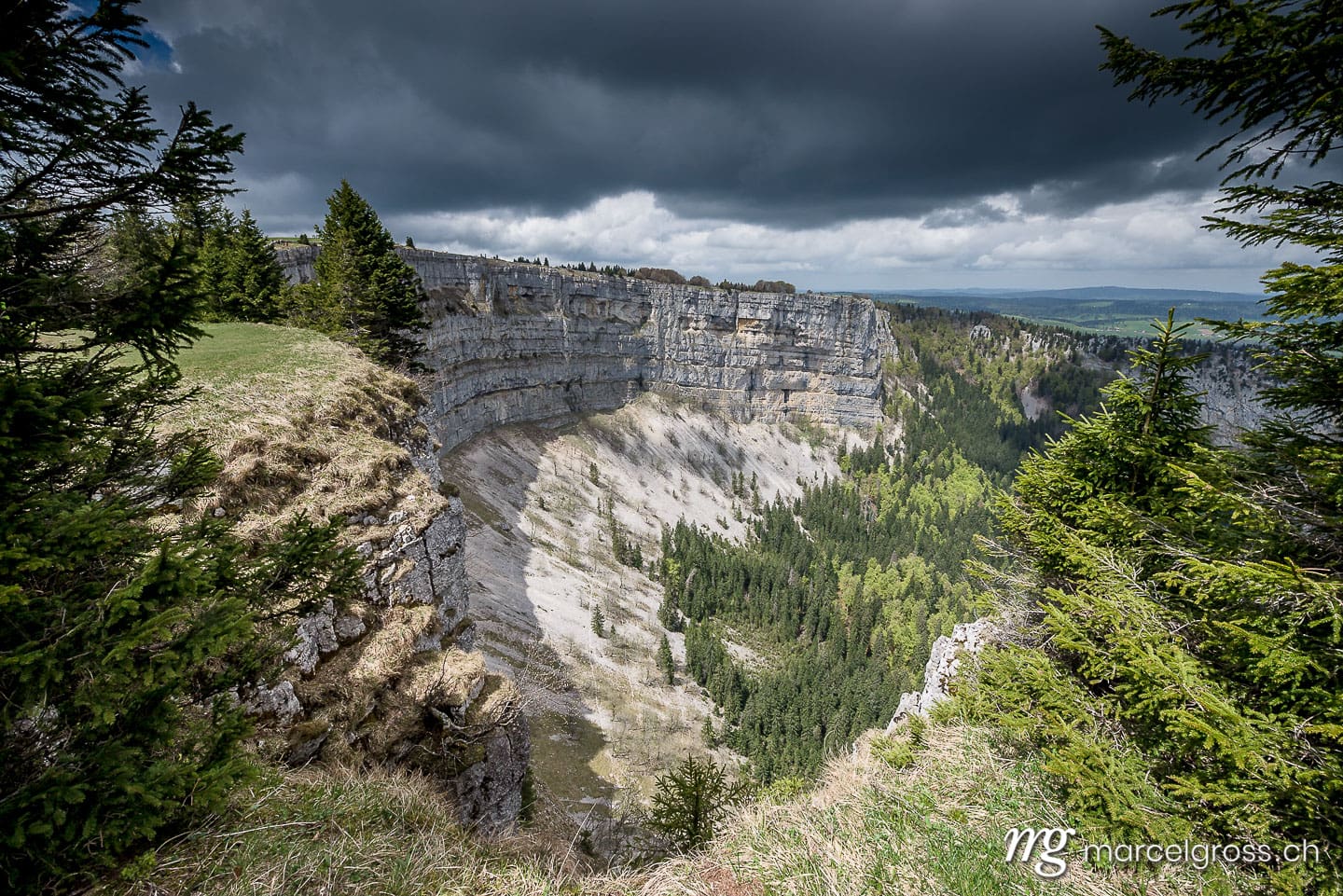 . spectacular view from Creux du Van with dark clouds. Marcel Gross Photography