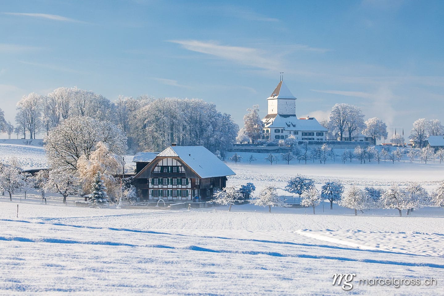 Winter picture Switzerland. perfect winter day in Emmental with a typical farm house and Schloss Schlosswil. Marcel Gross Photography