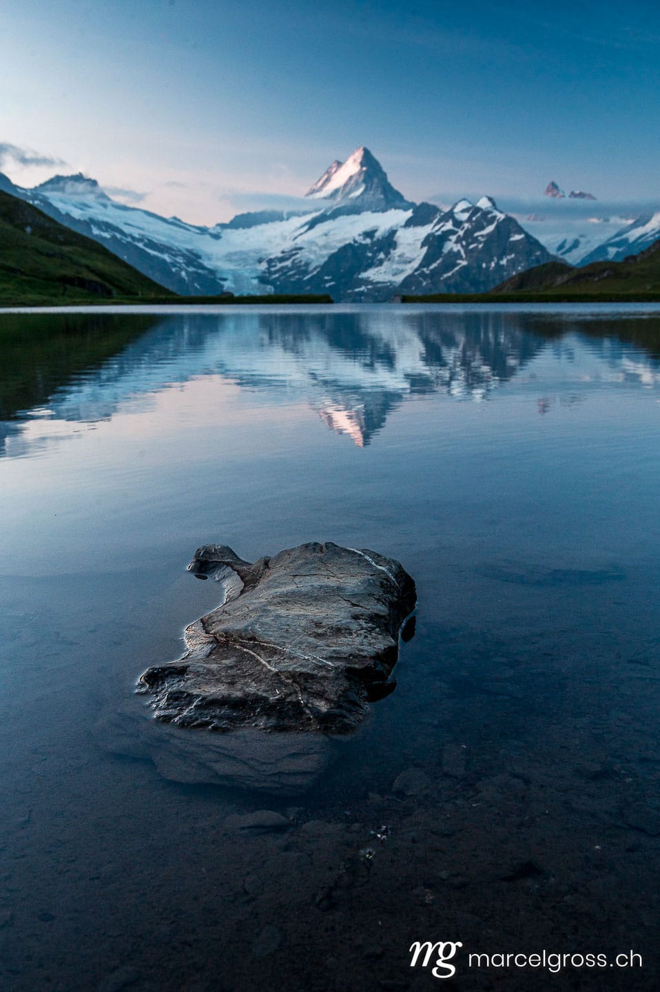 . Schreckhorn at sunrise seen at a calm Lake Bachalpsee. Marcel Gross Photography