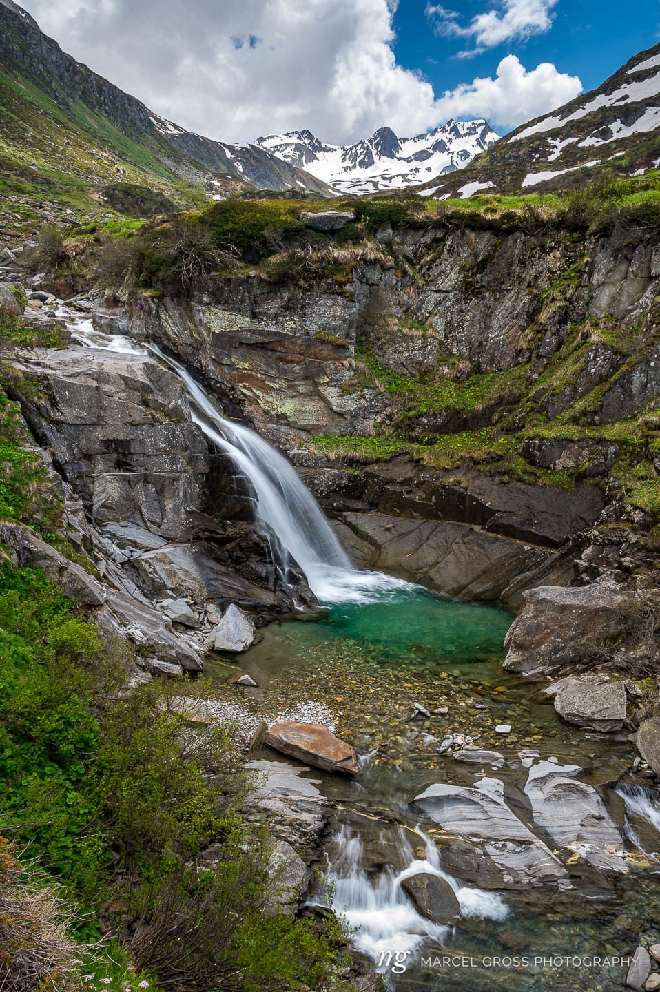 Long exposure of a small waterfall with a pool in the Unteralptal near Andermatt. Taken by Marcel Gross Photography