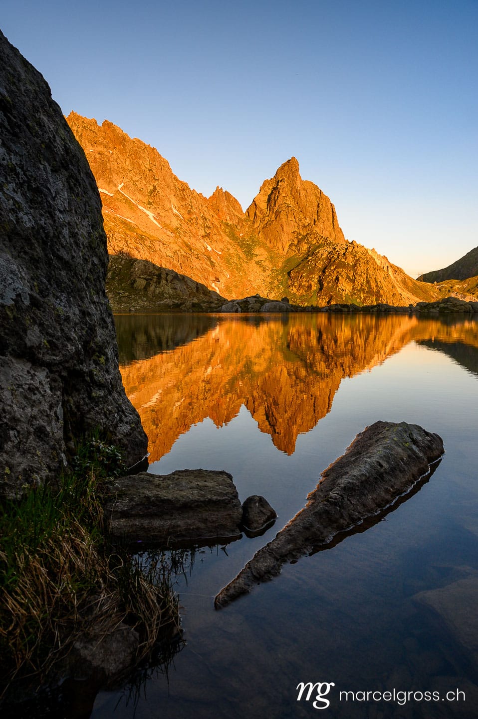 . calm Lago di Lei and Pizzo Prèvat in the Ticino Alps at sunrise. Marcel Gross Photography